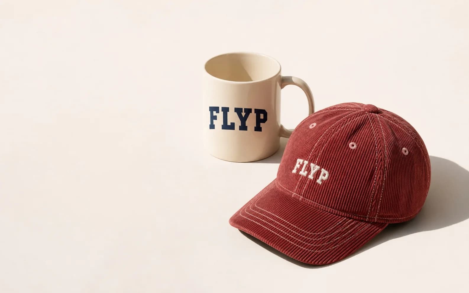 A FLYP sample — branded mug and corduroy cap