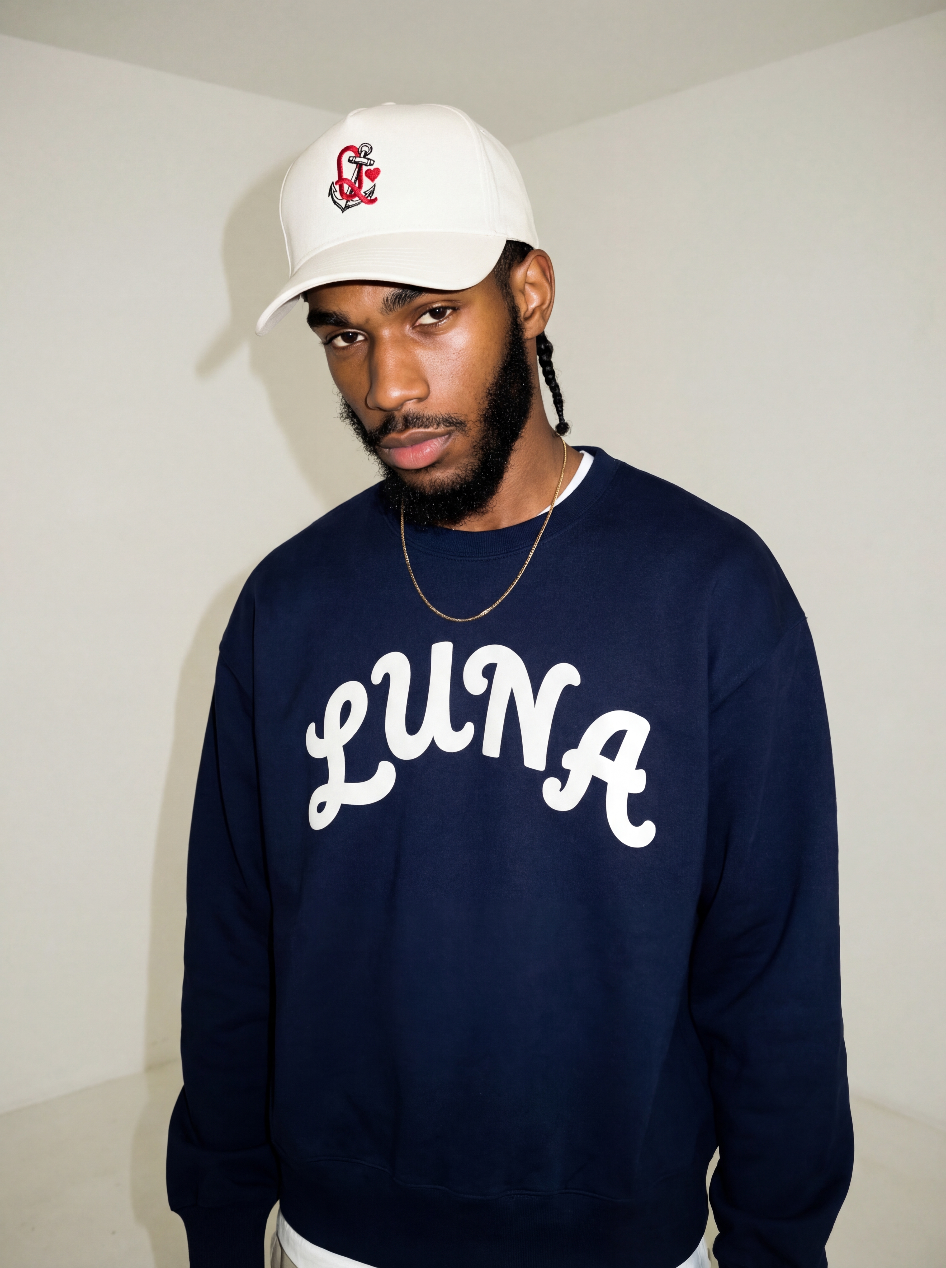 Creator wearing Luna crewneck and embroidered cap